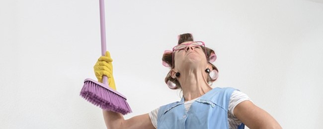 tenant poking ceiling of rental home with broom